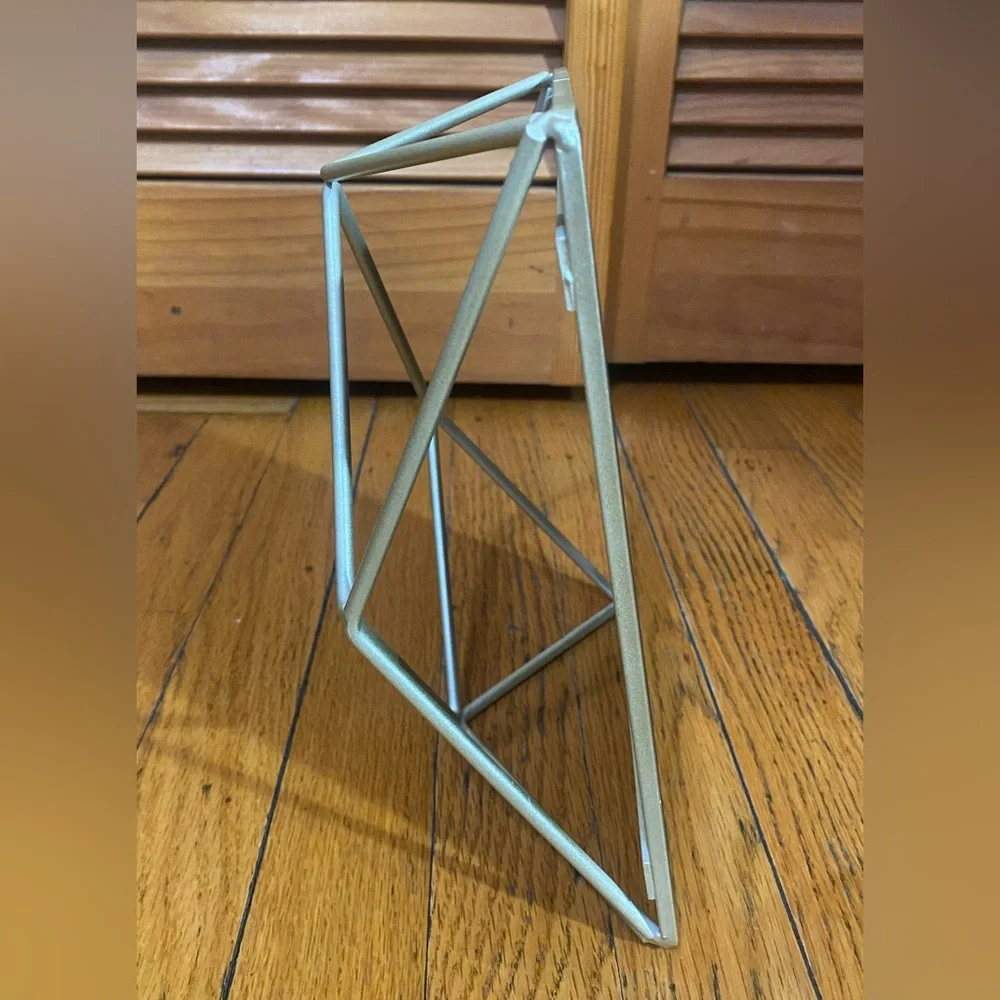 Mirror with geometric metalwork